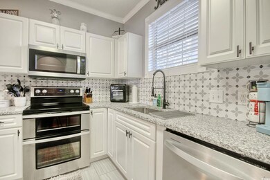 Kitchen with stainless steel appliances, white cab