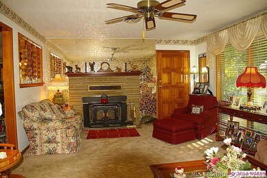 Formal living room with wood burning fireplace.