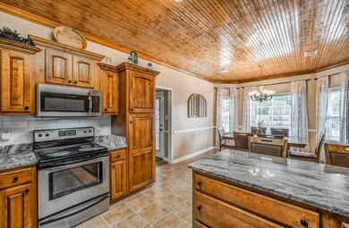Kitchen with light tile patterned flooring, an inv