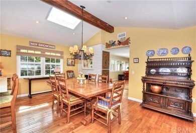The dining room has distressed maple wood floors, 