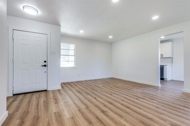 Foyer with light wood-style flooring, baseboards, 