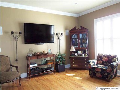 Great Room with beautiful Hardwood Floors; Crown Molding, Plantation Shutters & Decorator Colors!