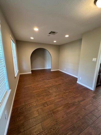 Empty room featuring dark wood finished floors an