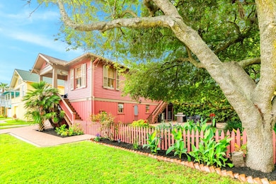 The home is perched on a lushly landscaped yard wi
