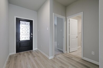 The light filled foyer boasts luxury vinyl plank flooring.