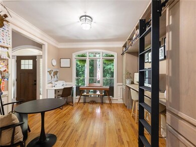 Foyer featuring crown molding and light wood finished floors