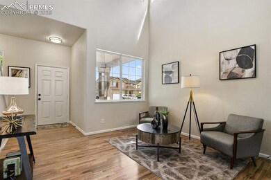 Sitting room featuring wood finished floors, baseb