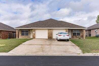 Ranch-style home with a garage, concrete driveway