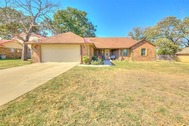 Ranch-style home featuring a front lawn and a gara