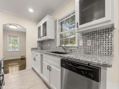 Kitchen featuring decorative backsplash, stainless