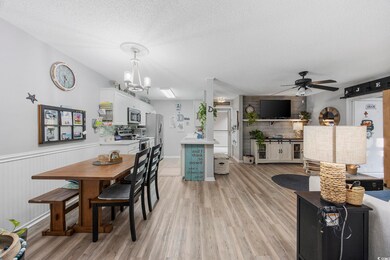Dining area with wood walls, a textured ceiling, l