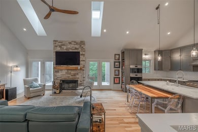 spacious great room with added skylights and wood burning fireplace