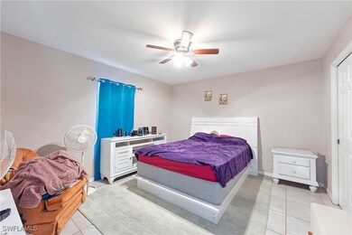 Bedroom featuring light tile patterned floors, cei
