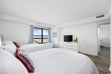Bedroom with access to outside and hardwood / wood