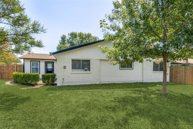 Back of property with a lawn