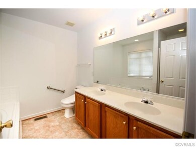 Master bath with double vanity, tub, and shower