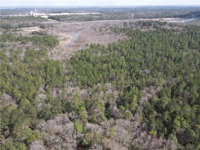 Aerial view featuring a wooded view