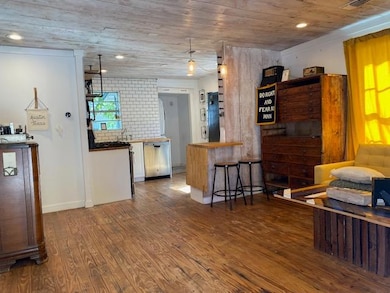 Kitchen with dishwasher, wood finished floors, wo