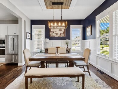 Off of the well appointed entry you’ll find the dining room w/ wainscotting and chandelier w/ decorative framing that is open to kitchen.