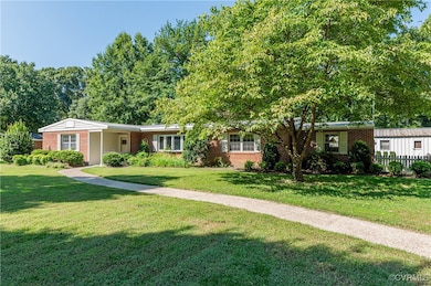 Single story home featuring a front lawn