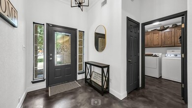 Foyer entrance with a high ceiling and washing machine and clothes dryer