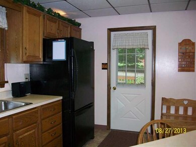 Kitchen. kitchen door leads to back porch for a sh