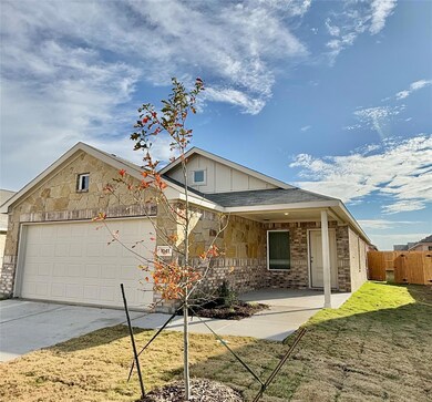 View of front of property with a garage and a front lawn