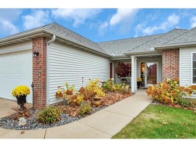 Covered front entry. Very nice custom landscaping.