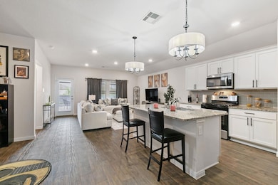 Kitchen featuring stainless steel appliances, ope