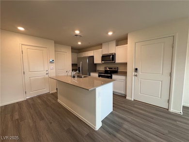 Kitchen with visible vents, a sink, appliances wit