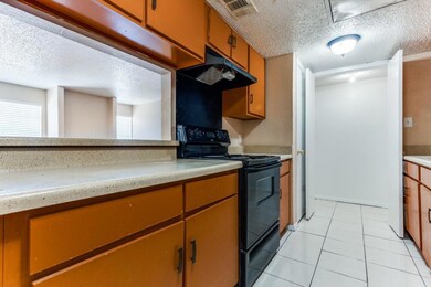 Kitchen with light tile patterned floors, electric