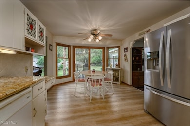 Dining area off of the kitchen with ceiling fan and lots of windows