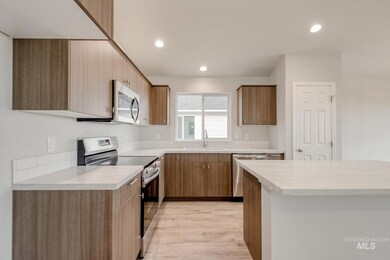 Kitchen featuring appliances with stainless steel finishes, light countertops, recessed lighting, light wood-style floors, and modern cabinets