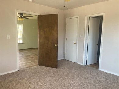 Unfurnished bedroom featuring baseboards and light colored carpet