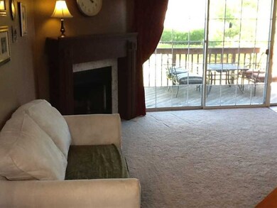 Living Room. Another view of the wall of windows with a patio door that leads to the large deck! Plenty of room for you furniture in this large living space that opens to the dining room!