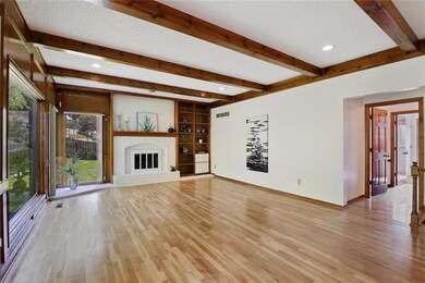 Floor to ceiling brick fireplace in sunny living r