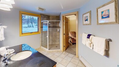 Bathroom with tile patterned flooring, vanity, a b