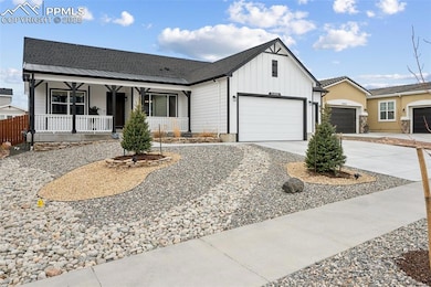 View of front of house with a porch, board and batten siding, and driveway