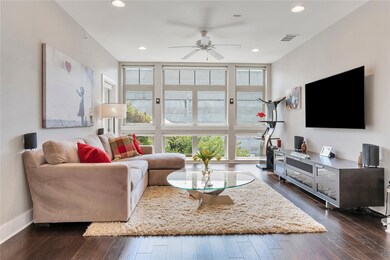 Living room featuring dark wood-style floors, bas