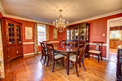 Large dining room has hardwood floors, crown moldi