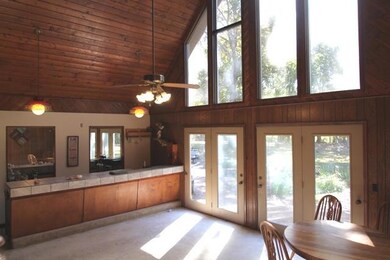 Den with wet bar and lots of natural lighting.