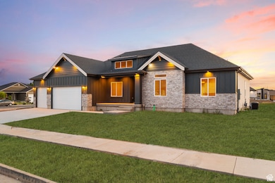Craftsman-style house with covered porch, stone siding, board and batten siding, and a front lawn