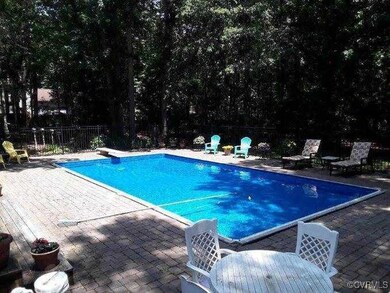 Pool featuring a patio area, fence, and a diving board