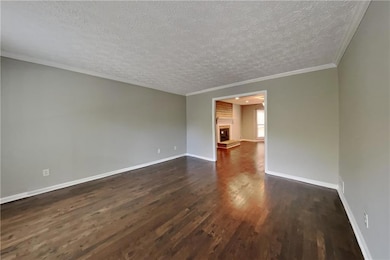 Spare room featuring stairway, a textured ceiling,