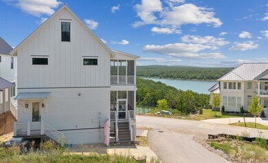 View of front of property with stairs, driveway, a