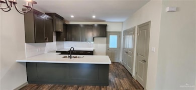 Kitchen featuring kitchen peninsula,sink