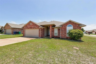 View of front facade featuring an attached garage, a front yard, and a shingled roof