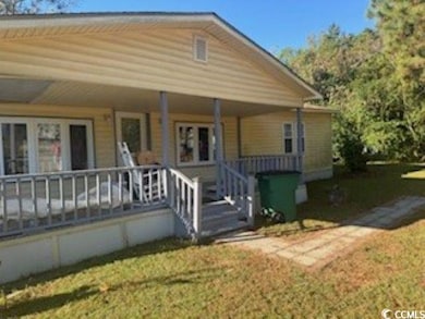 View of front facade featuring a porch and a front yard