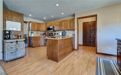 Kitchen with brown cabinetry, stainless steel appliances, decorative backsplash, light countertops, and recessed lighting