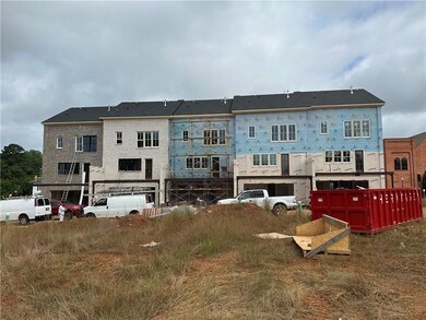 2 car garage w/ addition space on driveway for 2 cars, deck spans width of townhome